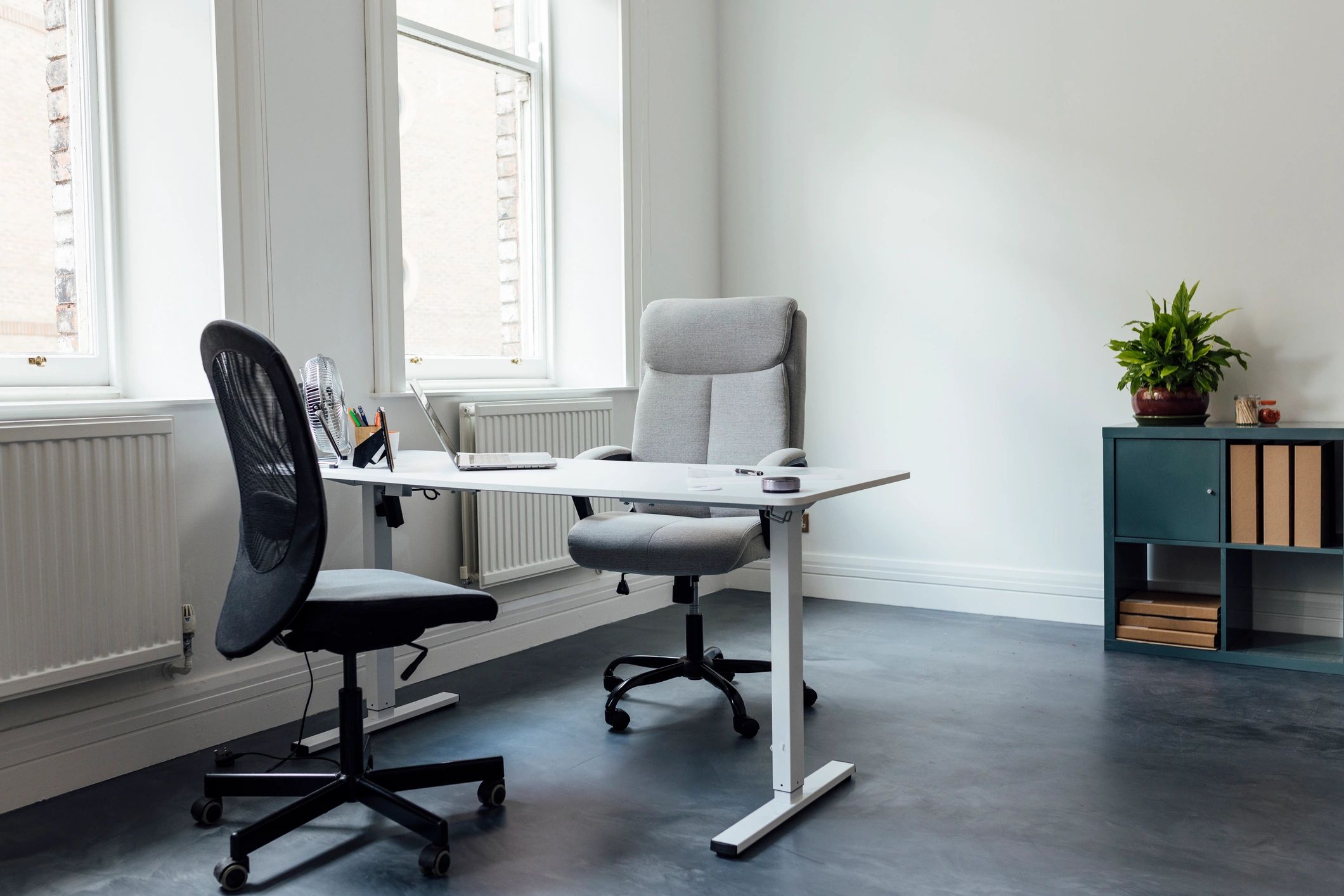 Modern design studio workspace with desk and chairs